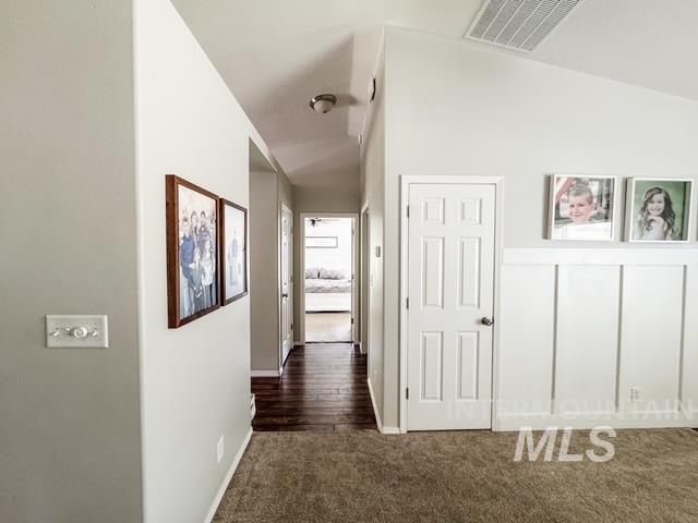 808 O'Leary Way Twin Falls, ID 83301 - Photo 15 of 37 Hallway featuring wood-finish flooring, light grey walls, and white paneled doors