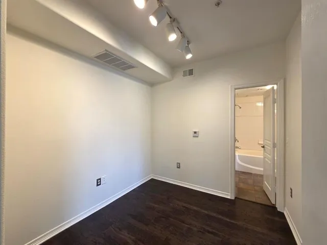 an empty room with wooden floor