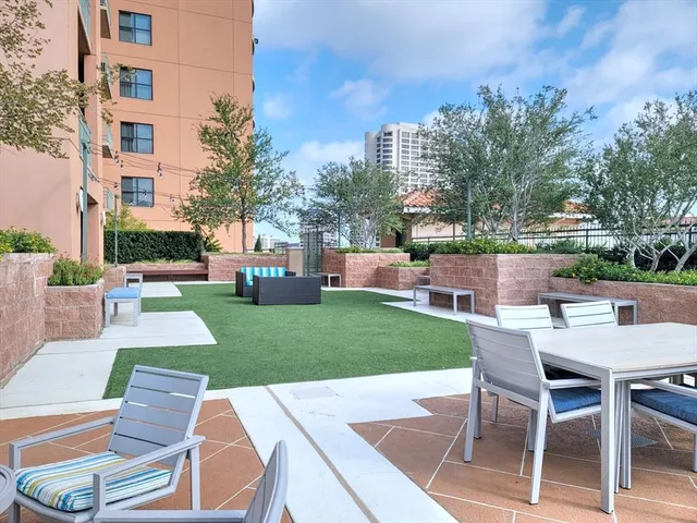 a view of backyard with outdoor seating and green space