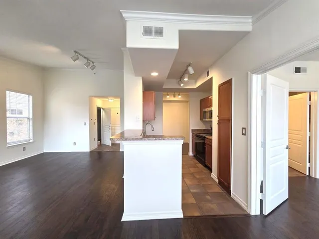 a view of a kitchen cabinets and wooden floor