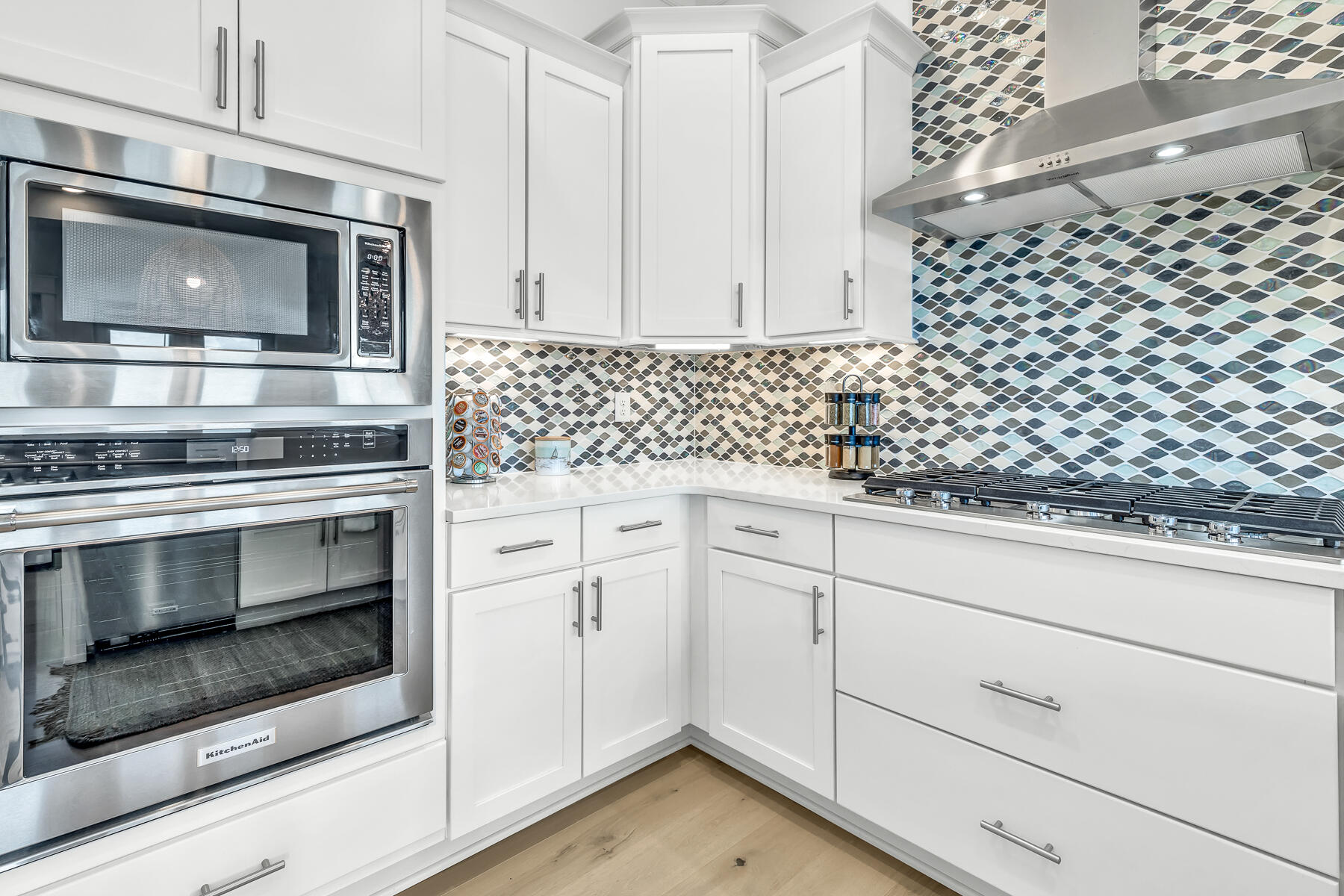 110 Wharf Ln Inlet Beach, Unit C Inlet Beach, FL 32461 - Photo 14 of 53 a kitchen with white cabinets stainless steel appliances and wooden floor
