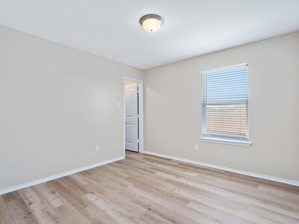 904 Lonesome Lilly Way Pflugerville, TX 78660 - Photo 25 of 34 The room features light wood-look flooring, light-colored walls, and a window with blinds