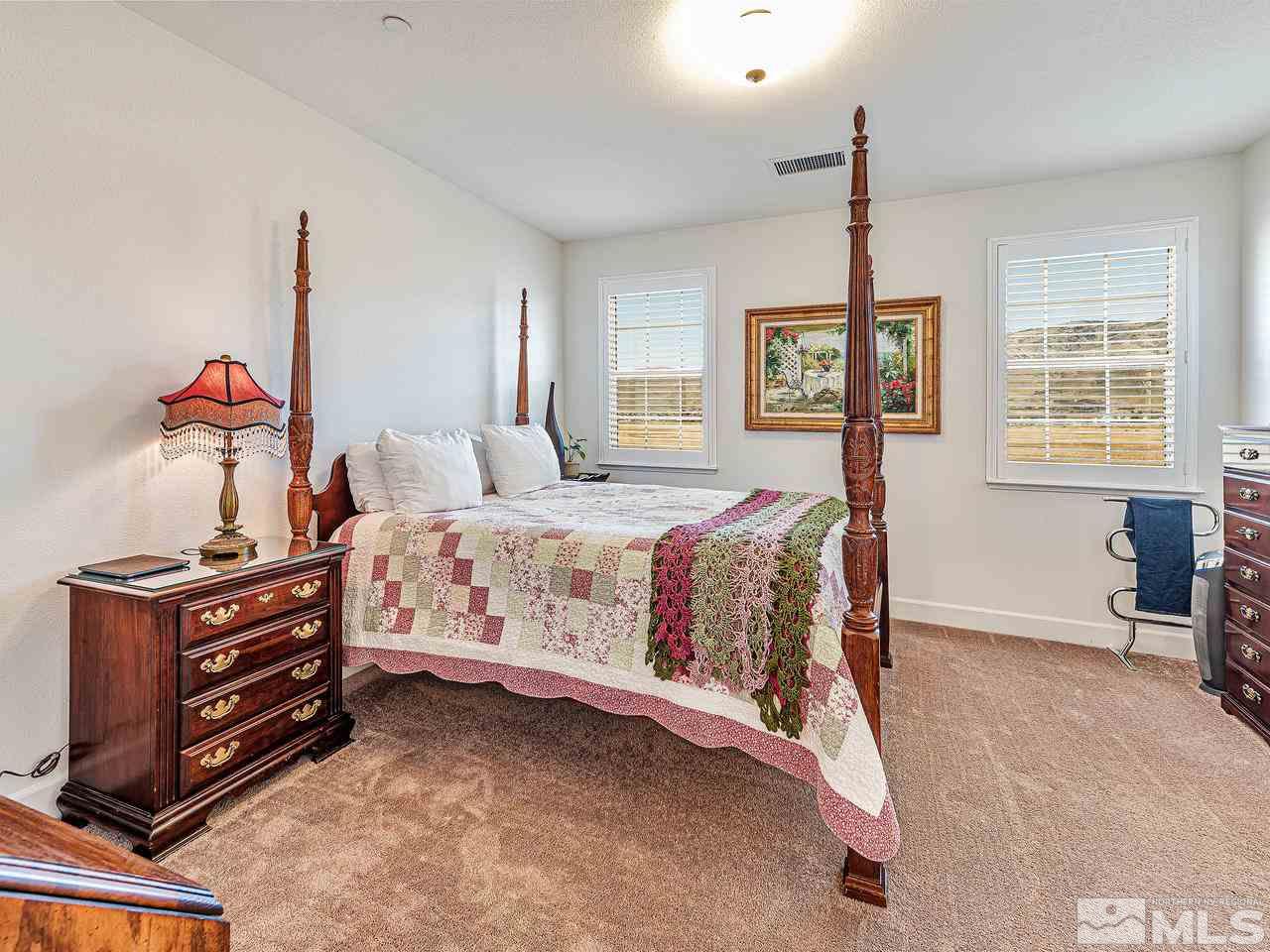 1890 Dark Horse Road, Unit 1062 Reno, NV 89521 - Photo 9 of 19 a large bed sitting in a room next to a window