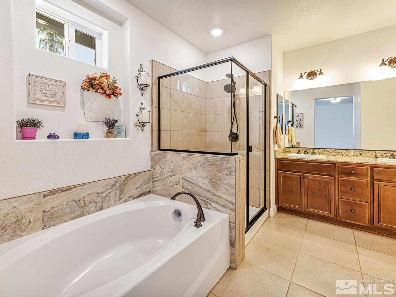 1890 Dark Horse Road, Unit 1062 Reno, NV 89521 - Photo 10 of 19 a bathroom with a tub a sink and a shower