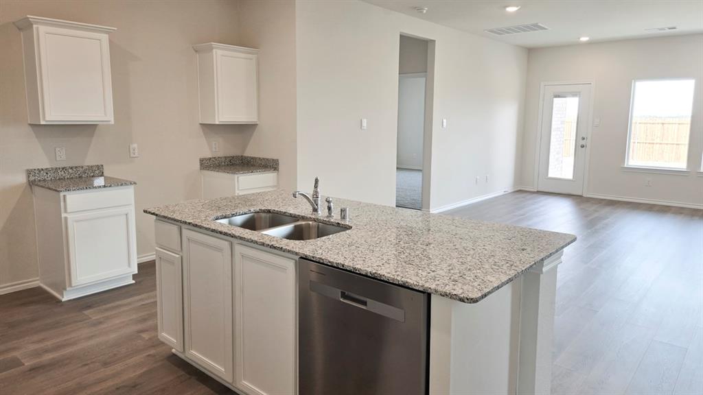 920 Jefferson Way Sherman, TX 75090 - Photo 16 of 21 a kitchen with a sink a stove a refrigerator and white cabinets