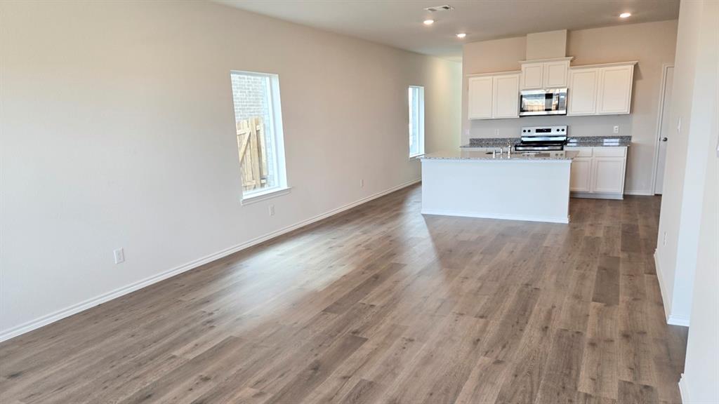 920 Jefferson Way Sherman, TX 75090 - Photo 19 of 21 a kitchen with wooden floors and stainless steel appliances