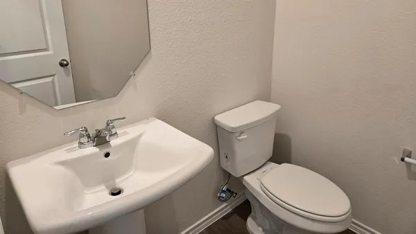 a white toilet sitting next to a white sink