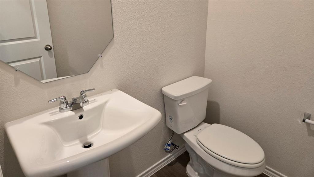 920 Jefferson Way Sherman, TX 75090 - Photo 4 of 21 a white toilet sitting next to a white sink