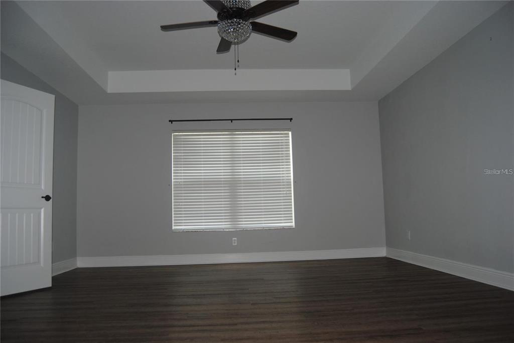 1167 Southeast 63rd Ct Road Ocala, FL 34472 - Photo 11 of 37 a view of an empty room with wooden floor and a window
