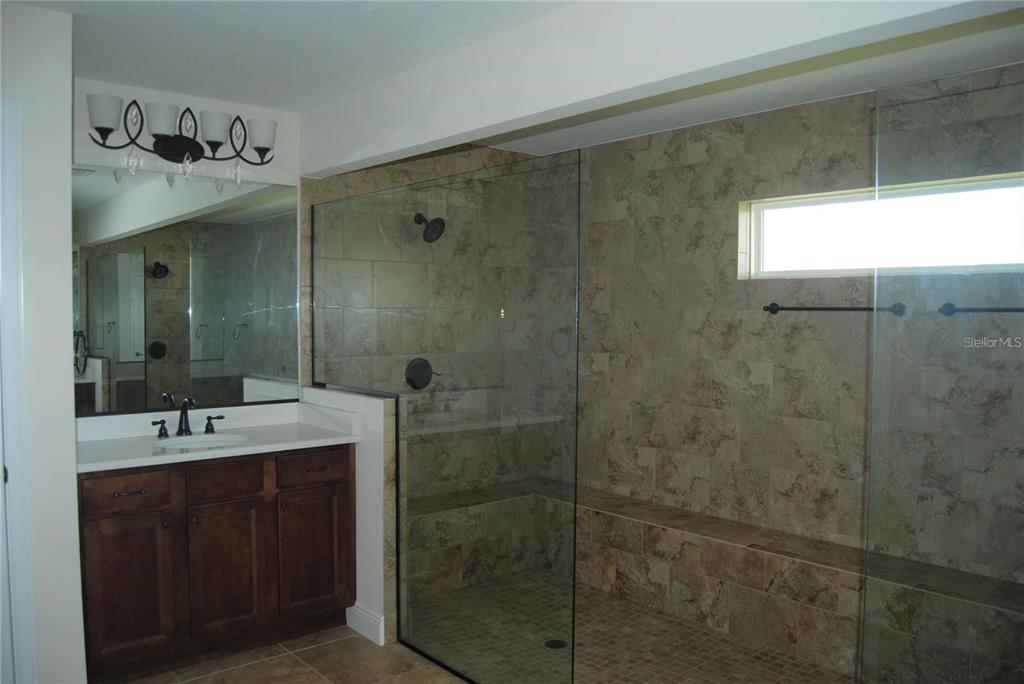 1167 Southeast 63rd Ct Road Ocala, FL 34472 - Photo 17 of 37 a bathroom with a double vanity sink mirror and shower