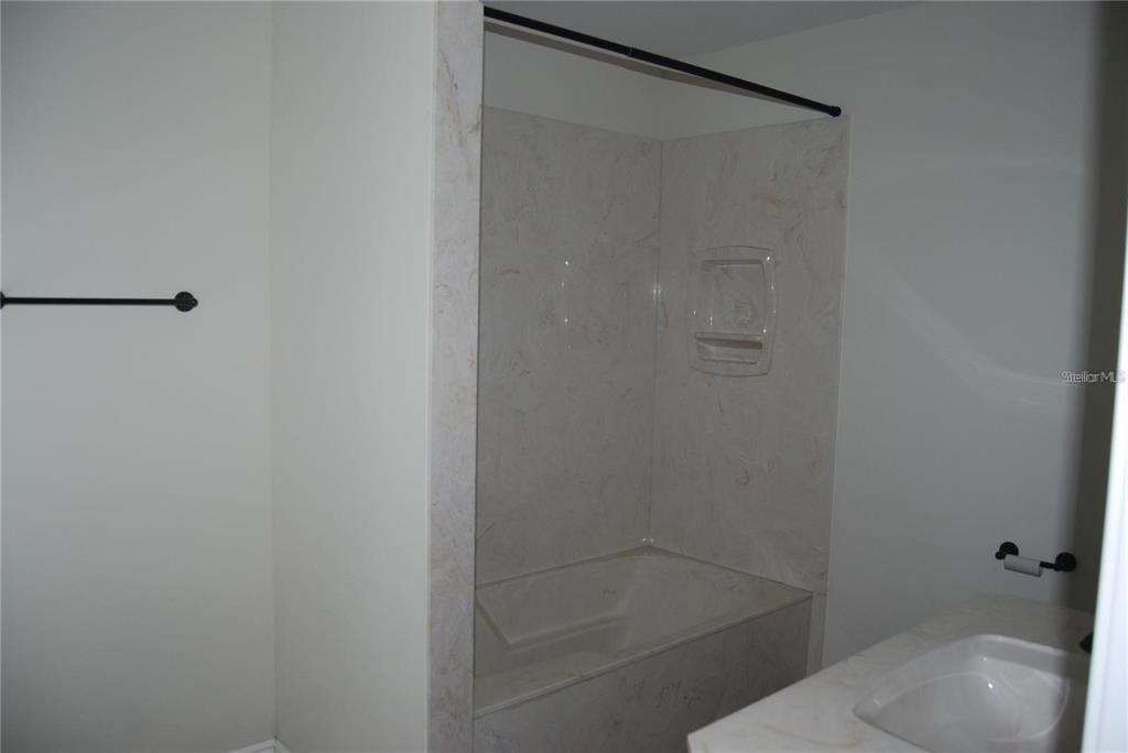 1167 Southeast 63rd Ct Road Ocala, FL 34472 - Photo 20 of 37 a bathroom with a shower and toilet