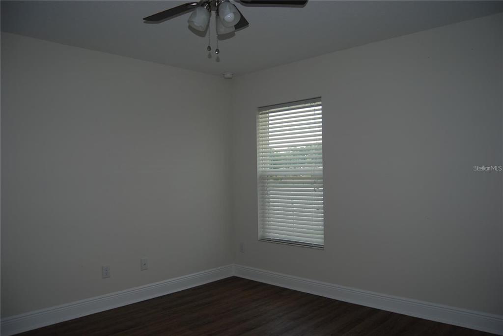 1167 Southeast 63rd Ct Road Ocala, FL 34472 - Photo 25 of 37 a view of an empty room with wooden floor and a window