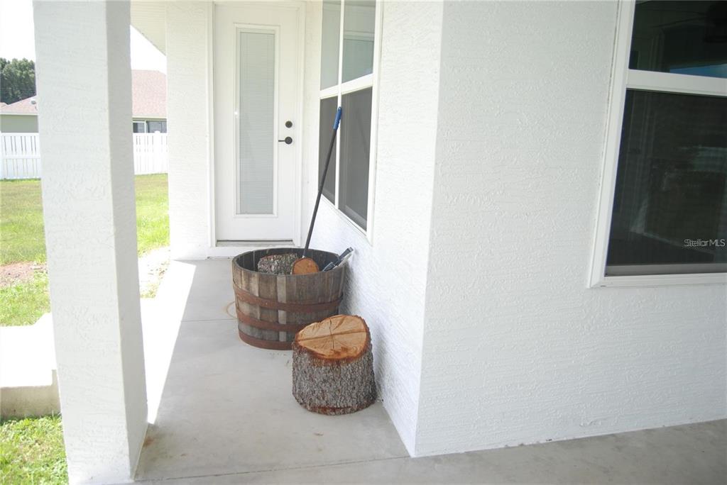 1167 Southeast 63rd Ct Road Ocala, FL 34472 - Photo 34 of 37 a room with a couch and a potted plant next to a window