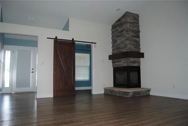 a view of a fireplace with wooden floor