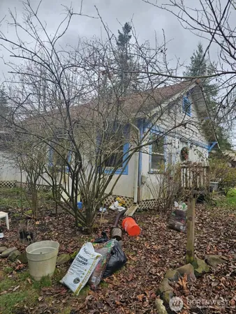 a backyard of a house with table and chairs