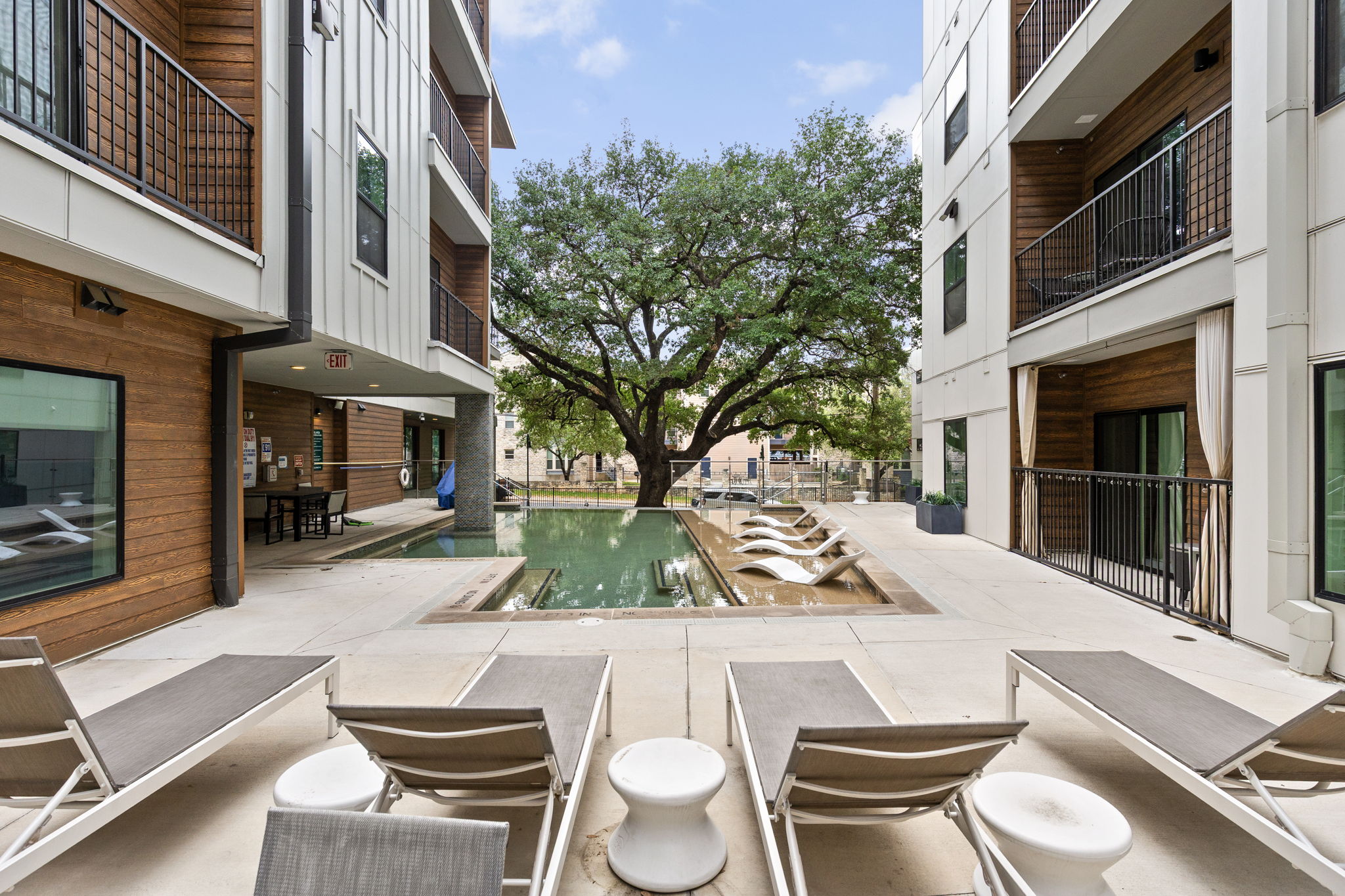2500 Longview Street, Unit 507 Austin, TX 78705 - Photo 32 of 37 An inviting courtyard with an outdoor pool and comfortable lounge seating for ultimate relaxation.