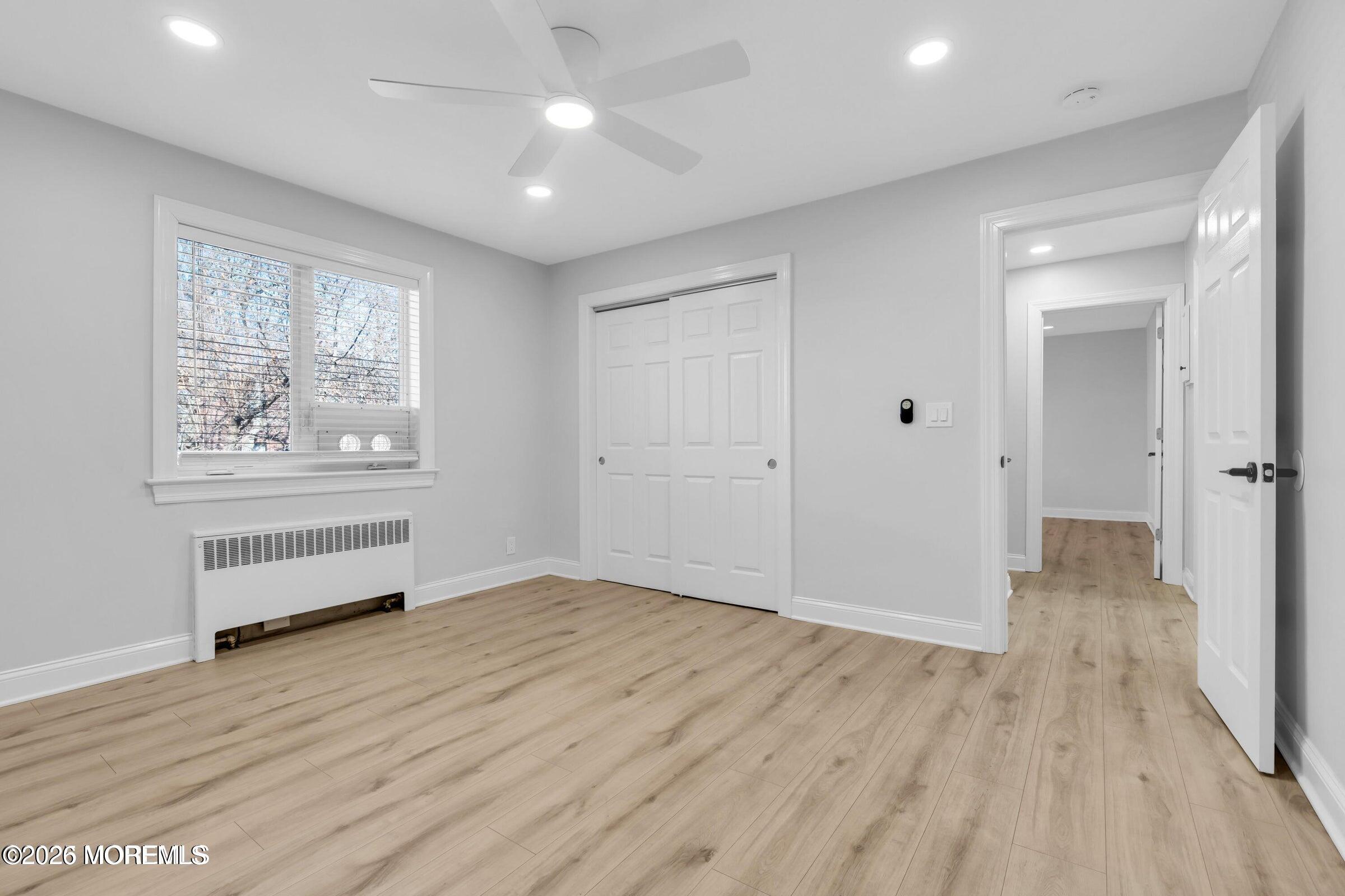 283 Spring Street, Unit 3A Red Bank, NJ 07701 - Photo 11 of 21 wooden floor in an empty room with a window