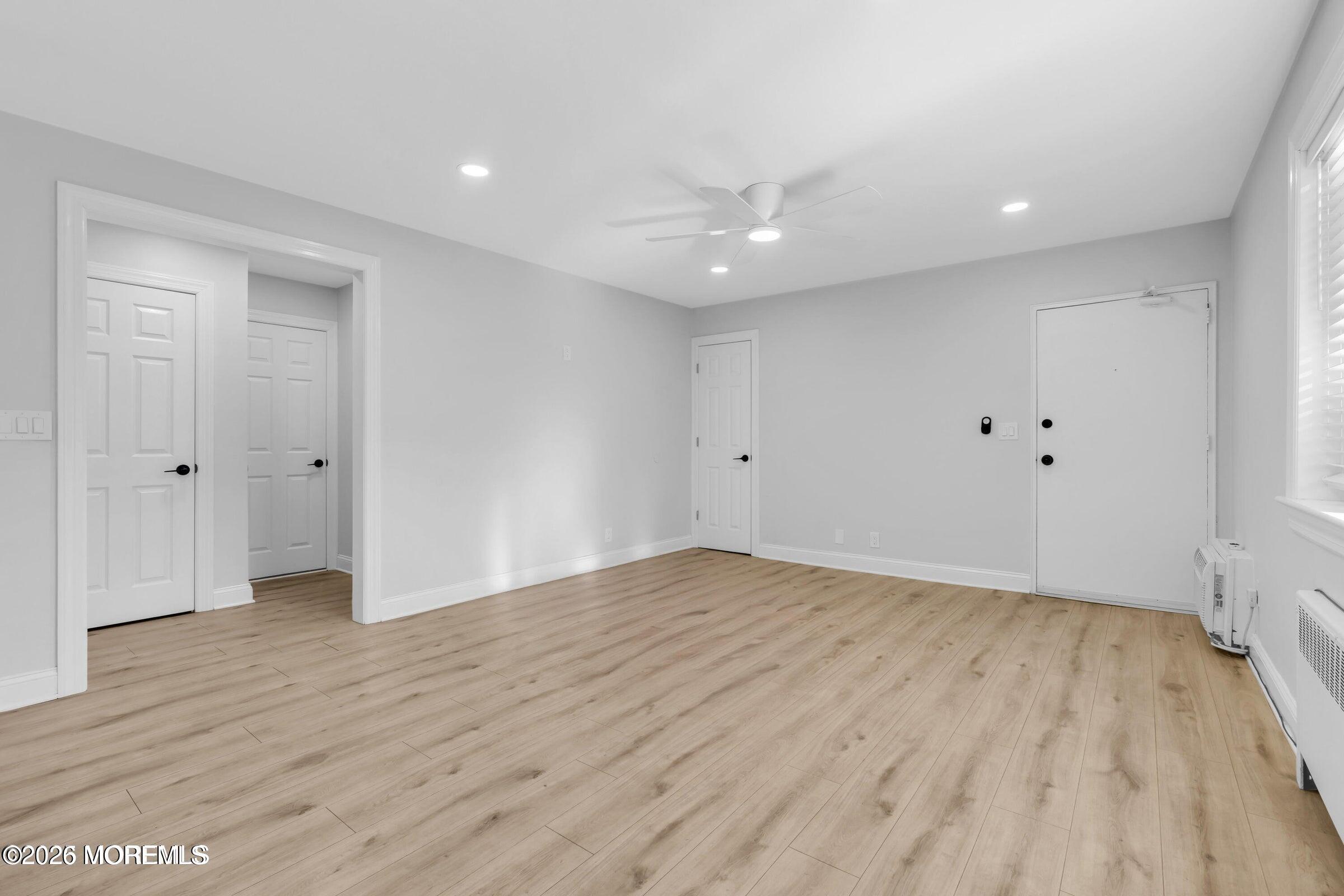 283 Spring Street, Unit 3A Red Bank, NJ 07701 - Photo 14 of 21 a view of an empty room with wooden floor