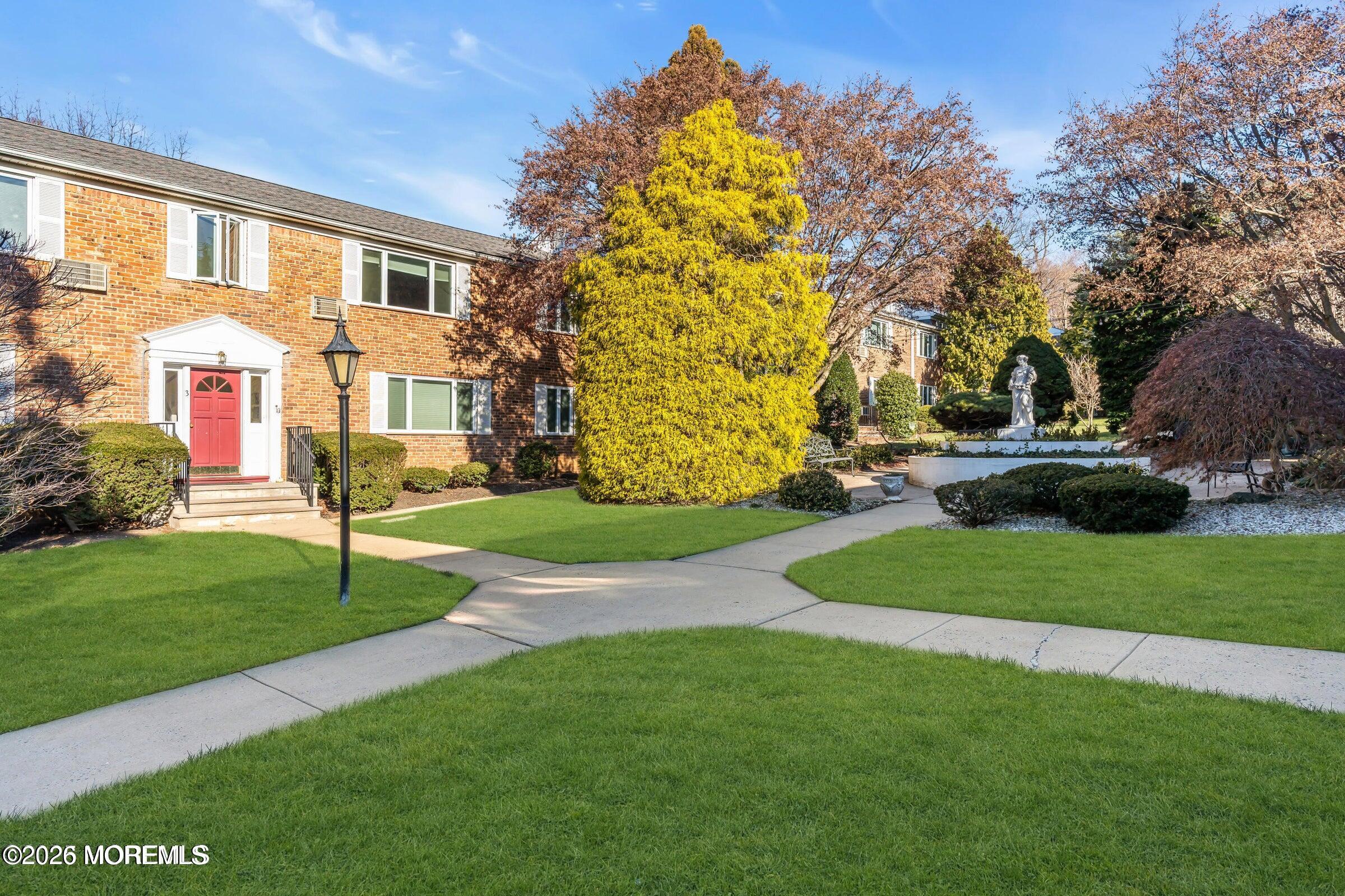 283 Spring Street, Unit 3A Red Bank, NJ 07701 - Photo 19 of 21 a house with garden in front of it