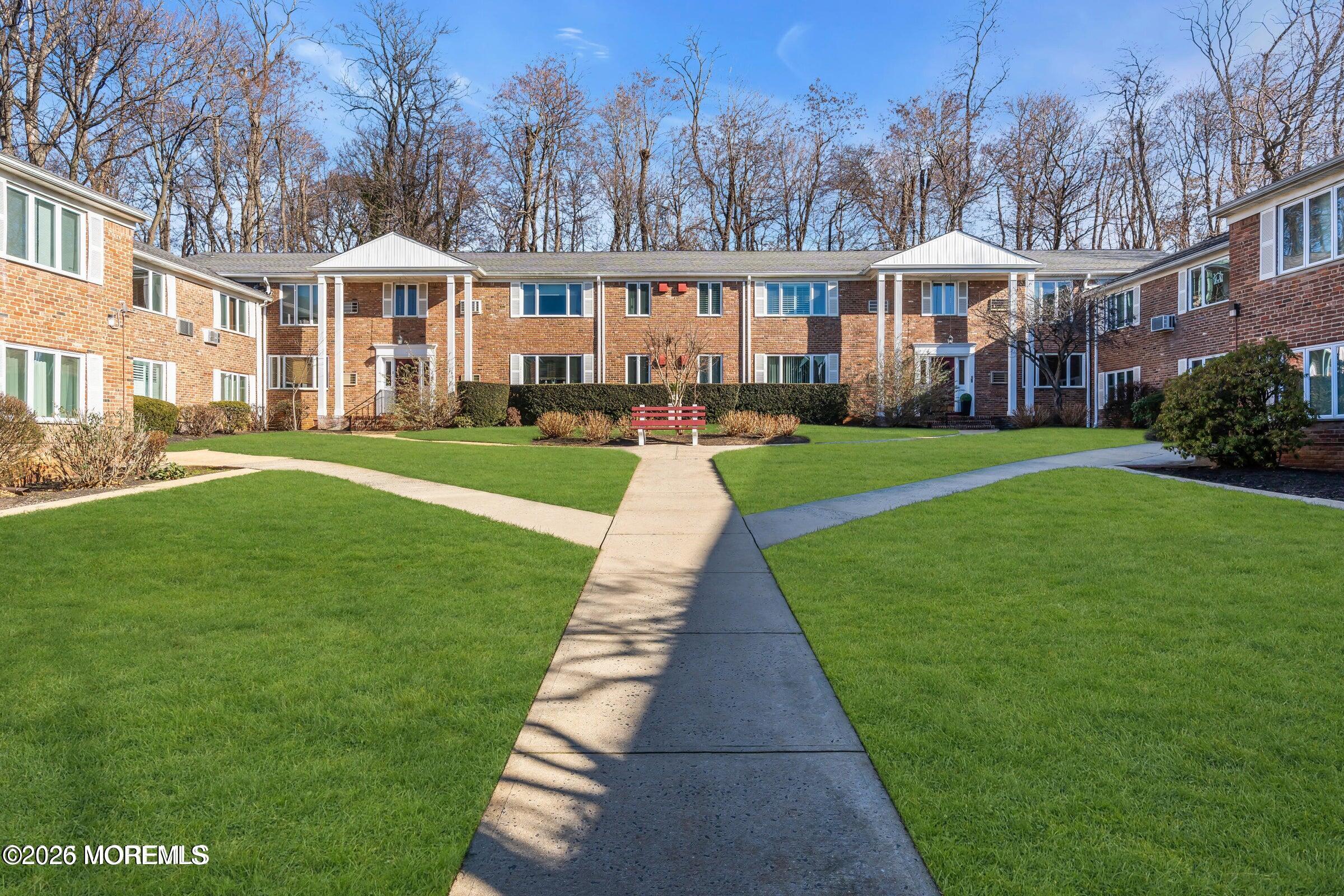 283 Spring Street, Unit 3A Red Bank, NJ 07701 - Photo 20 of 21 a front view of a residential apartment building with a yard