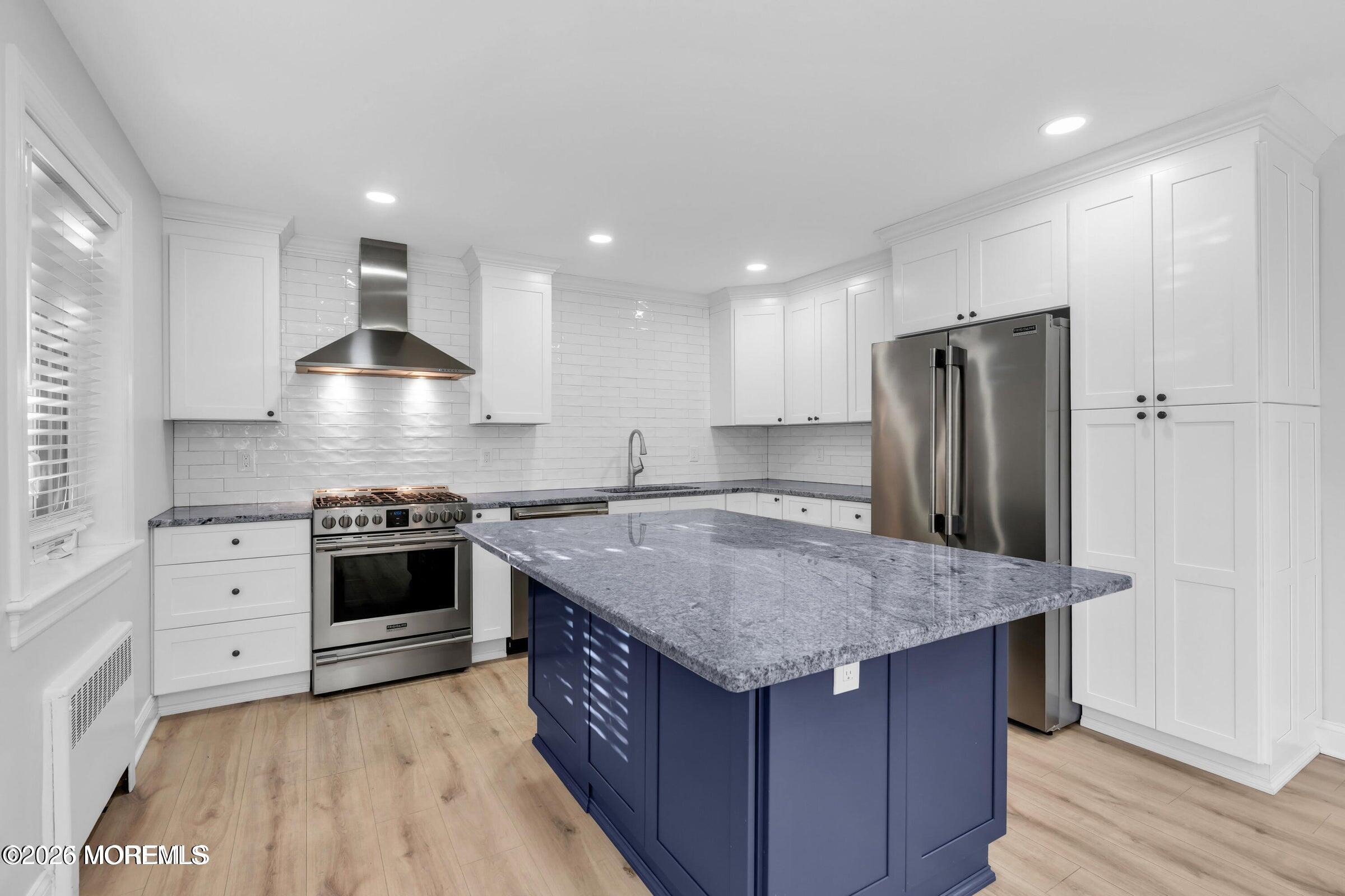 283 Spring Street, Unit 3A Red Bank, NJ 07701 - Photo 3 of 21 a kitchen with stainless steel appliances granite countertop a sink stove and refrigerator