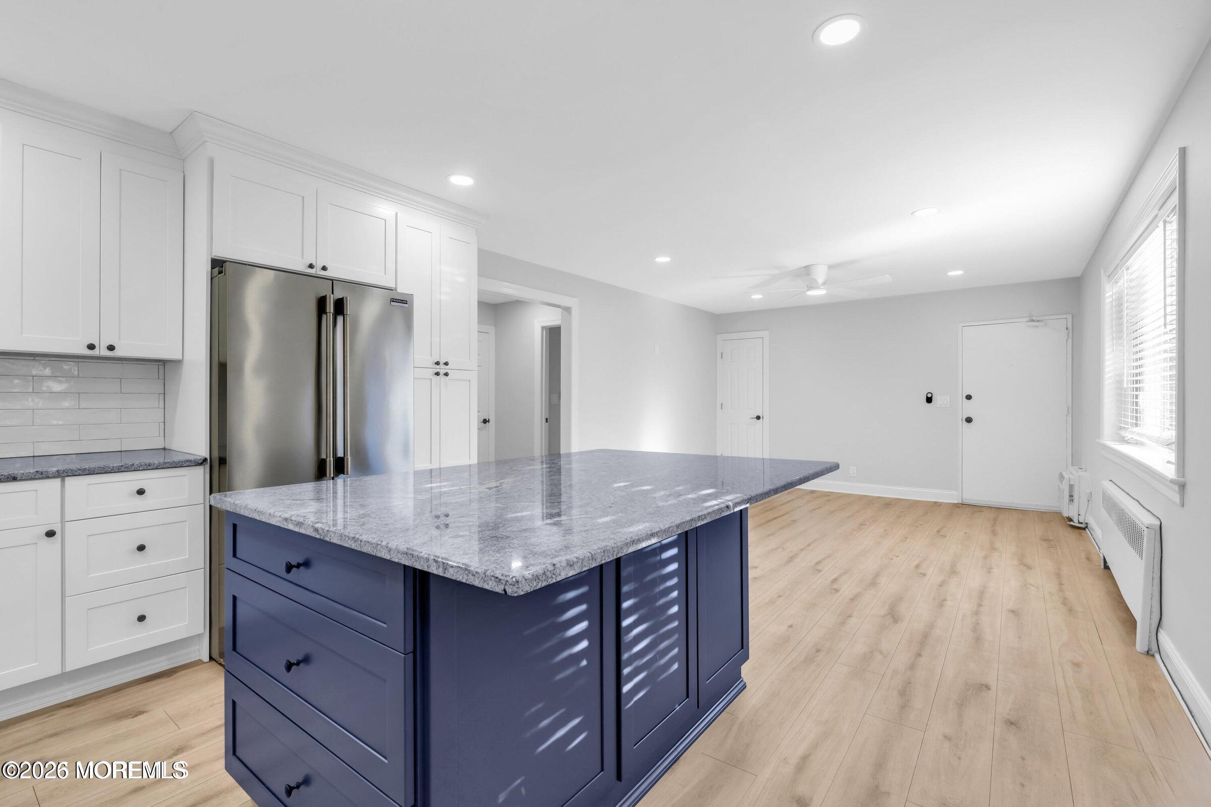 283 Spring Street, Unit 3A Red Bank, NJ 07701 - Photo 4 of 21 a kitchen with a sink a counter space and stainless steel appliances