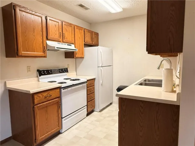 a kitchen with a sink and a refrigerator
