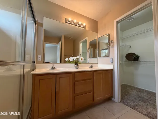 a bathroom with a double vanity sink and a mirror