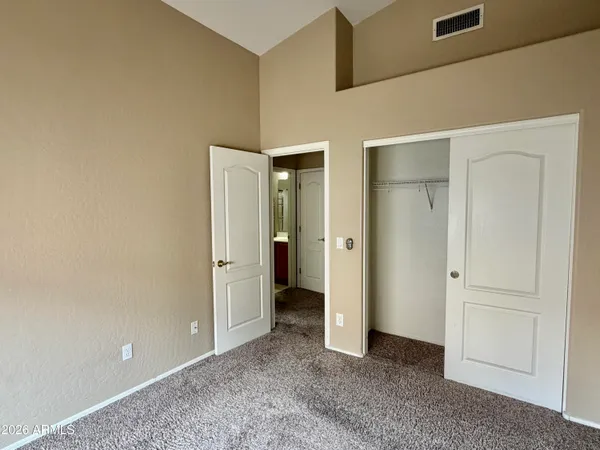 an empty room with closet area