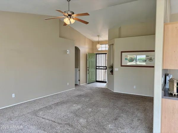 an empty room with fan and windows
