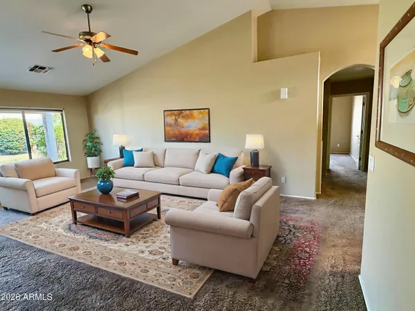 a living room with furniture and a chandelier