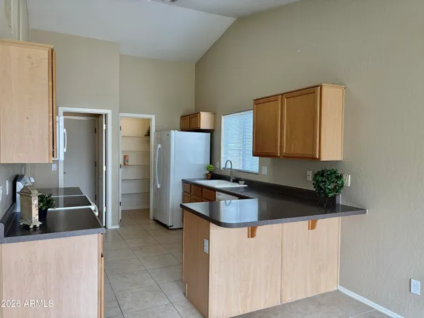 a kitchen with refrigerator and microwave