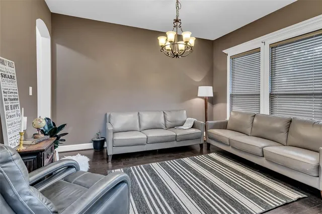 a living room with furniture and a chandelier