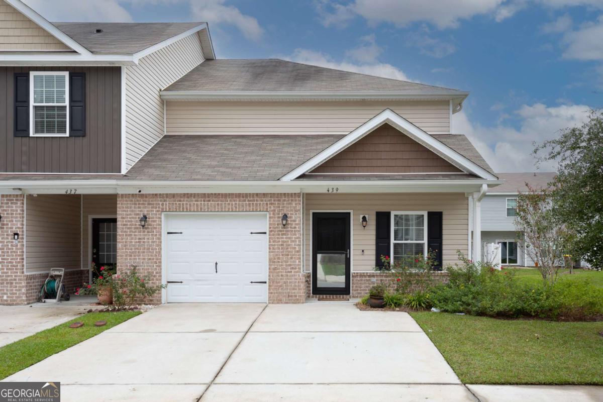 a front view of a house with yard