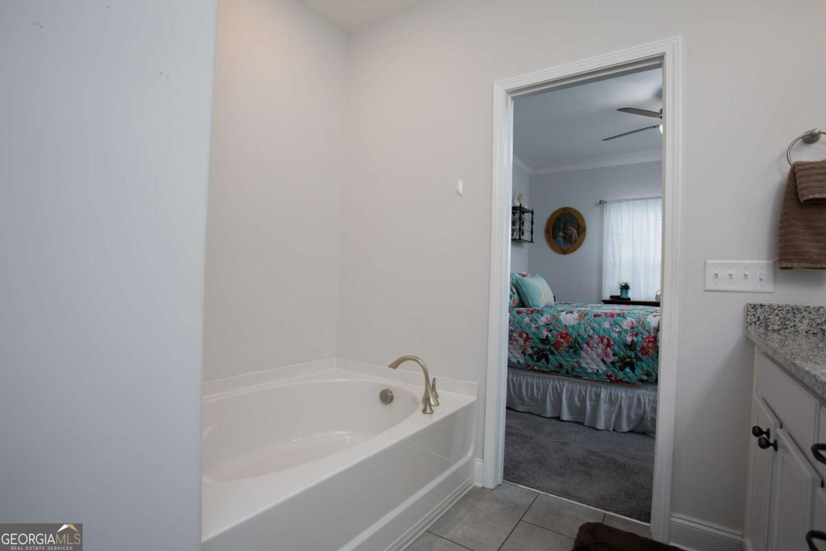 439 Gov Treutlen Circle Pooler, GA 31322 - Photo 11 of 21 a bathroom with a tub sink and mirror