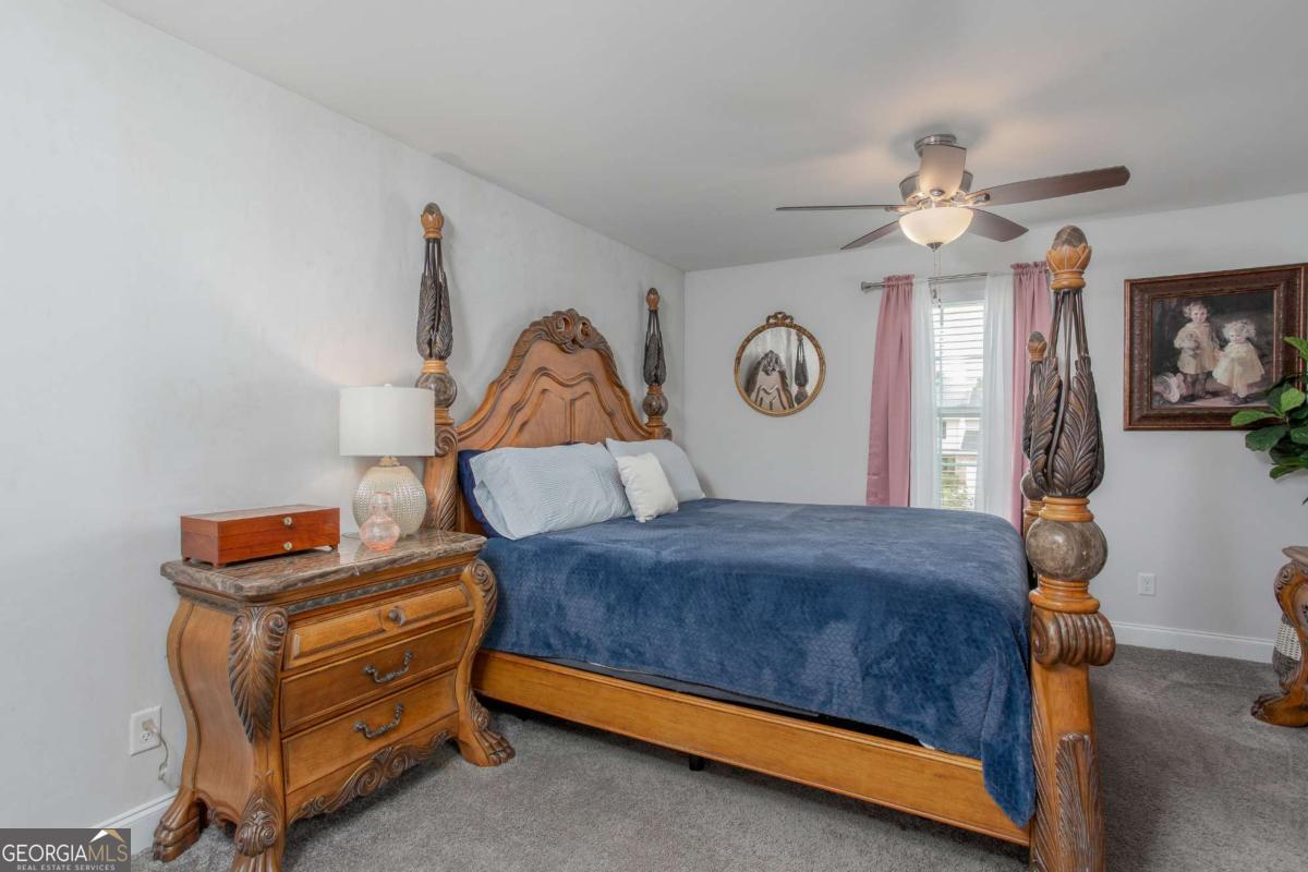 439 Gov Treutlen Circle Pooler, GA 31322 - Photo 12 of 21 a bedroom with a bed and a chandelier