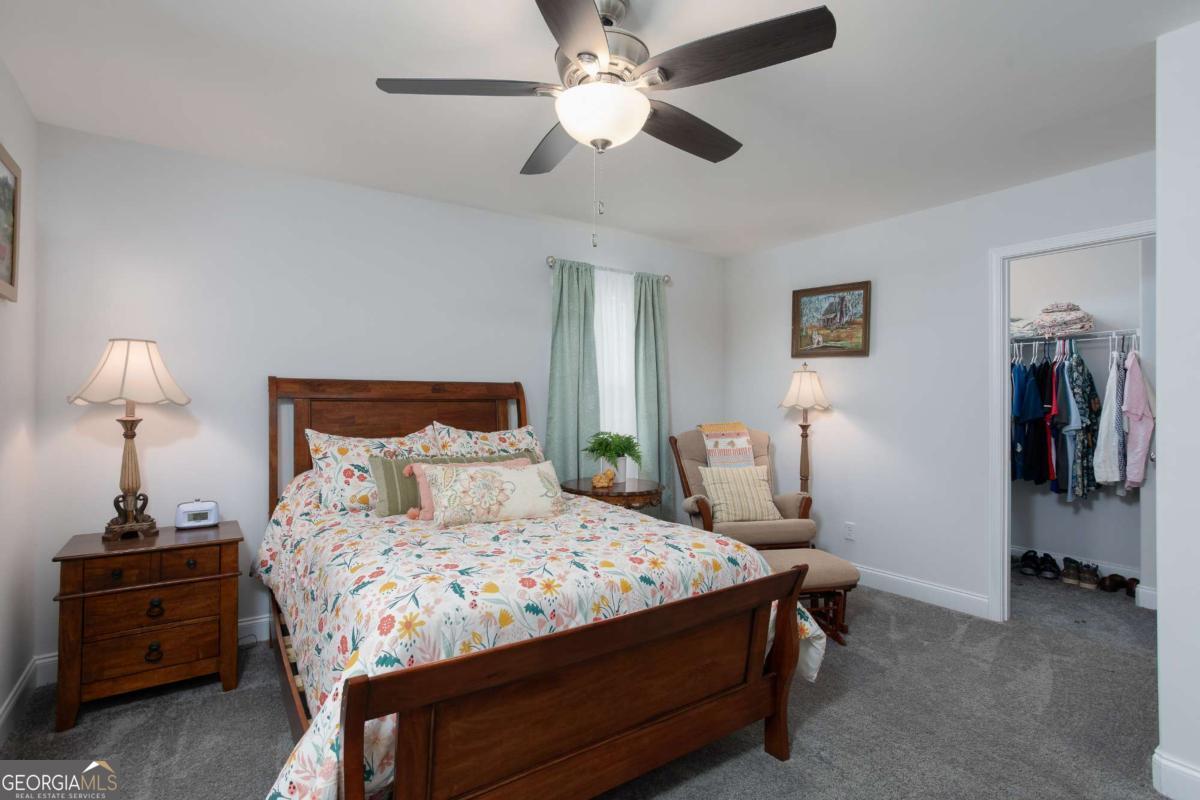 439 Gov Treutlen Circle Pooler, GA 31322 - Photo 15 of 21 a bedroom with a bed and a chandelier