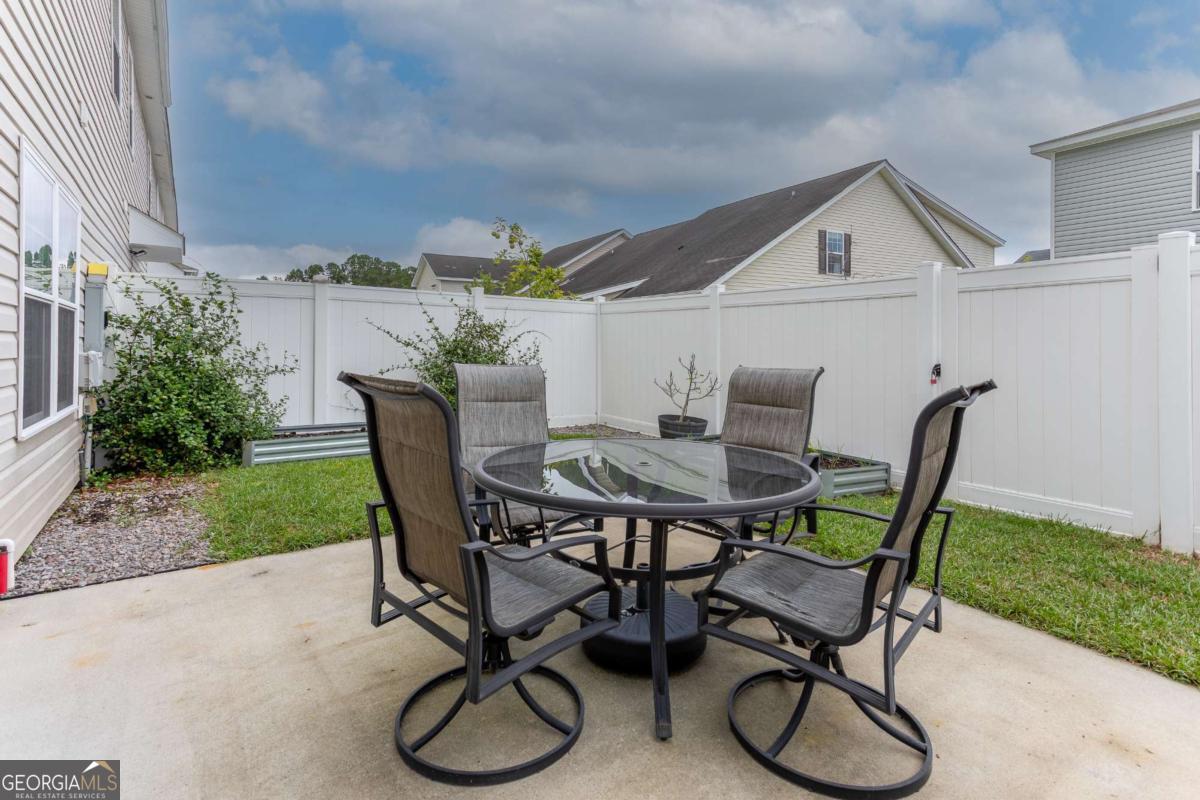 439 Gov Treutlen Circle Pooler, GA 31322 - Photo 18 of 21 a patio with a table and chairs