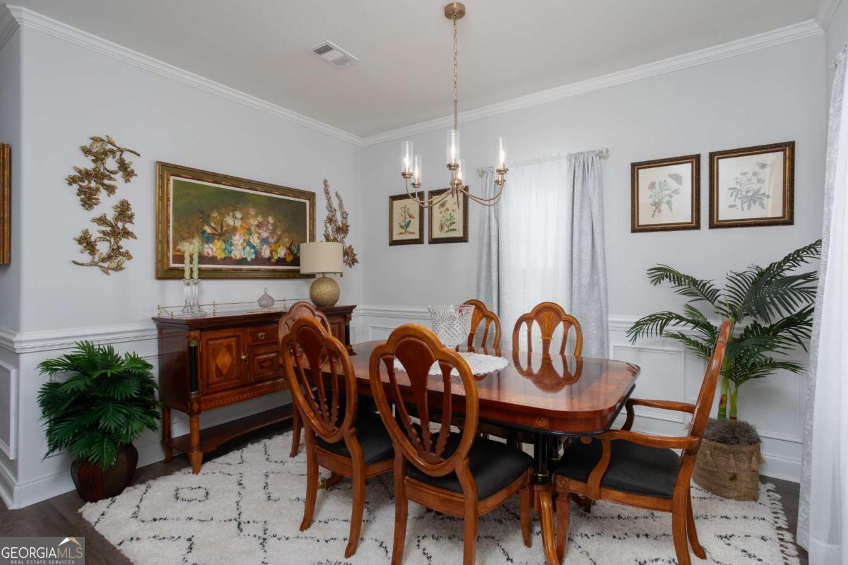 439 Gov Treutlen Circle Pooler, GA 31322 - Photo 3 of 21 a view of a dining room with furniture and chandelier