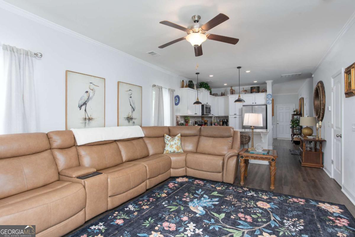 439 Gov Treutlen Circle Pooler, GA 31322 - Photo 8 of 21 a living room with furniture and a chandelier
