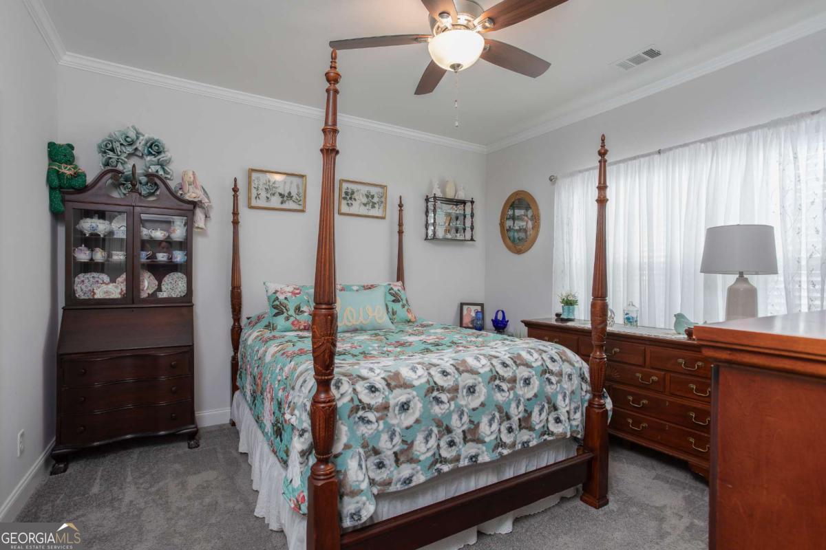 439 Gov Treutlen Circle Pooler, GA 31322 - Photo 9 of 21 a bedroom with a bed and a chandelier