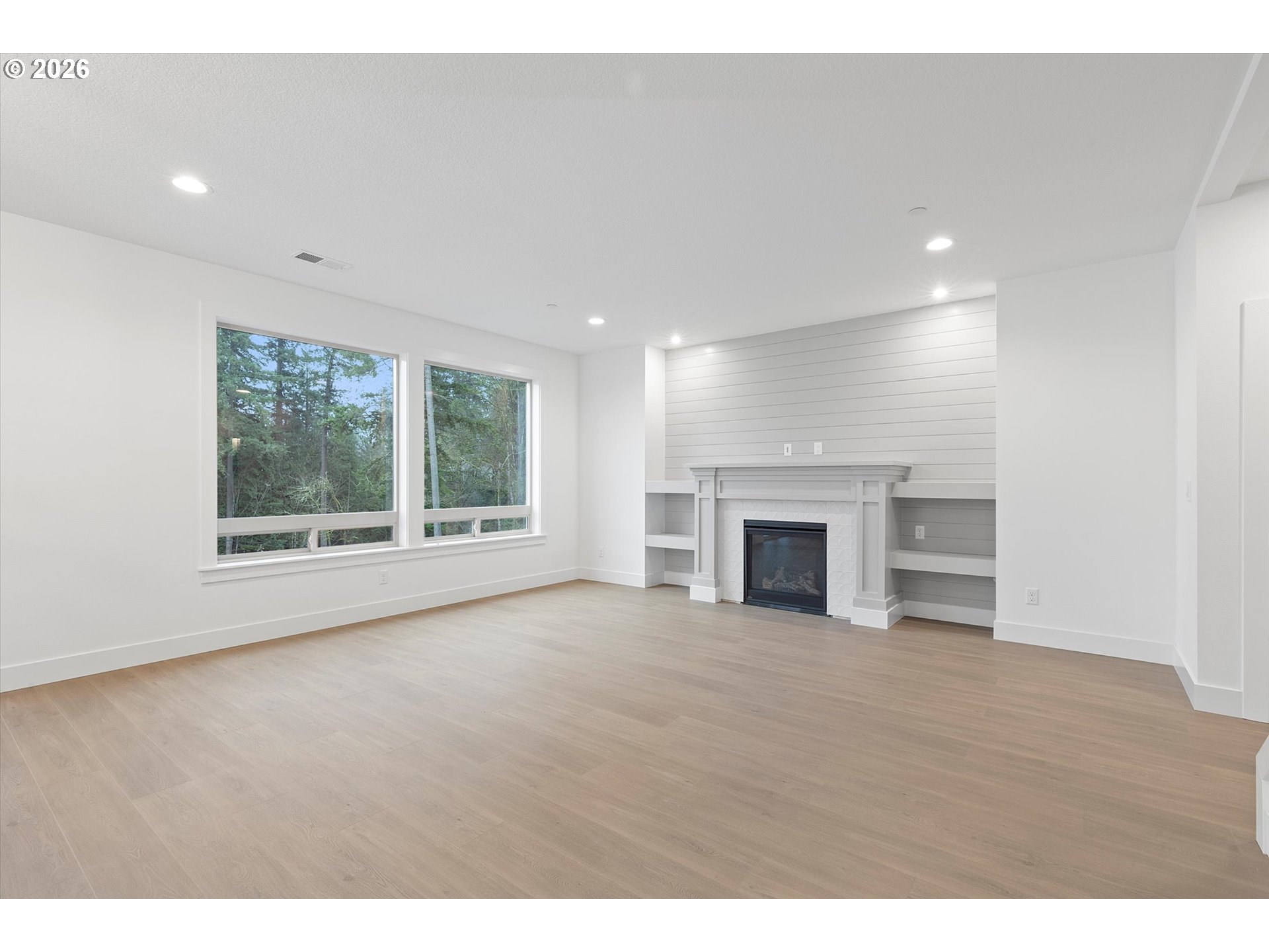 14992 Southeast Andre Way Clackamas, OR 97015 - Photo 5 of 42 a view of an empty room with a fireplace and a window