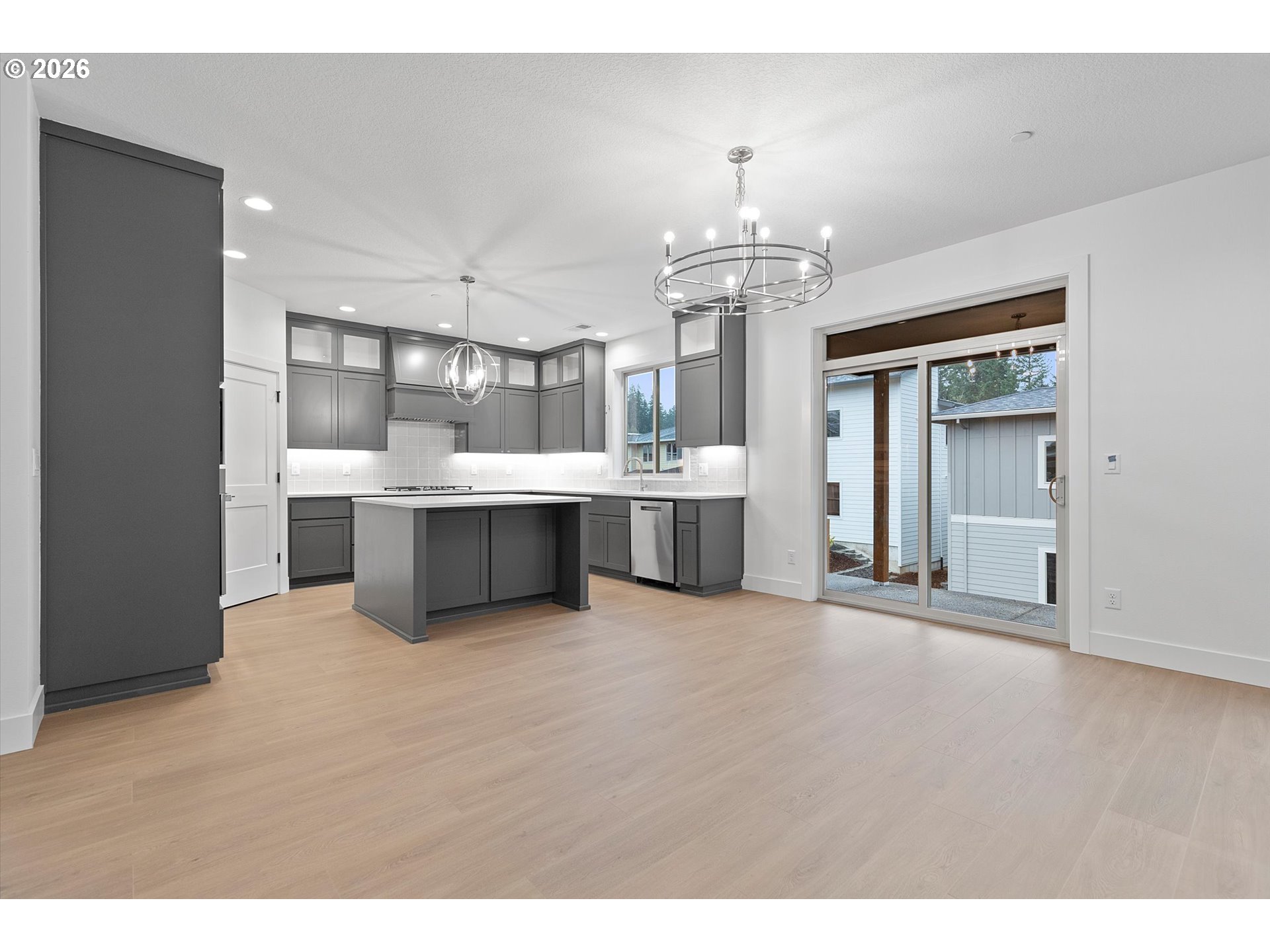 14992 Southeast Andre Way Clackamas, OR 97015 - Photo 8 of 42 a view of a big room with chandelier and wooden floors