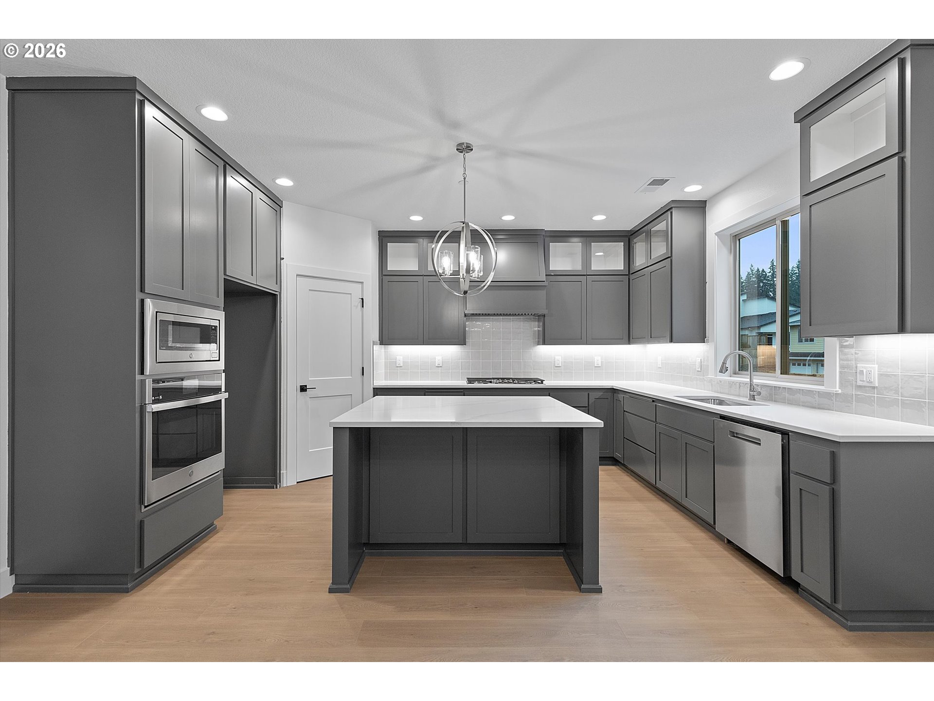 14992 Southeast Andre Way Clackamas, OR 97015 - Photo 9 of 42 a kitchen with kitchen island stainless steel appliances a sink stove and refrigerator