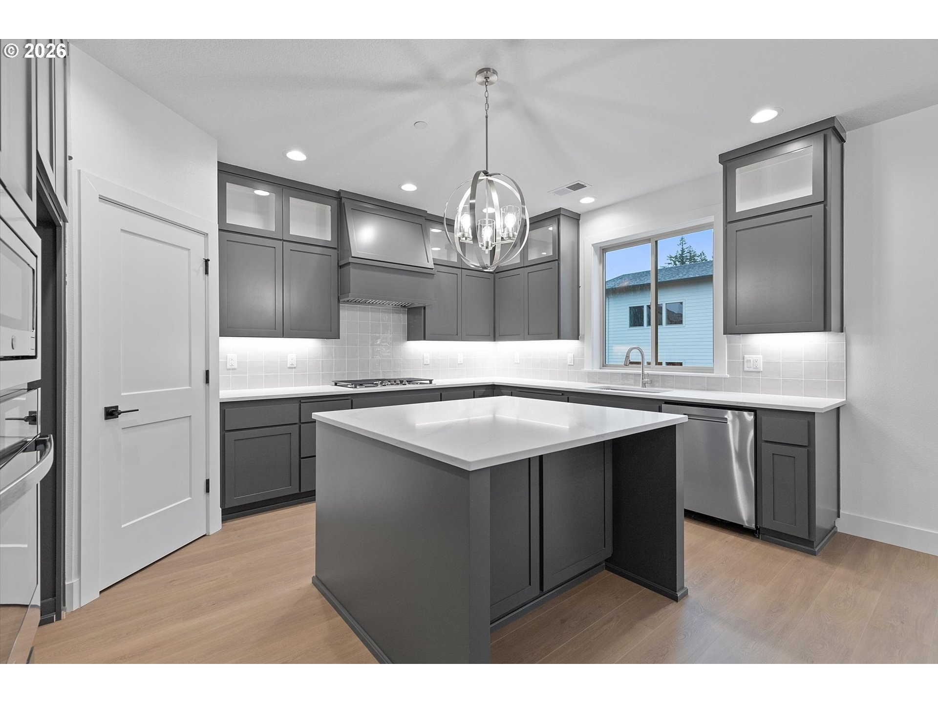 14992 Southeast Andre Way Clackamas, OR 97015 - Photo 10 of 42 a kitchen with kitchen island granite countertop a sink stove and refrigerator