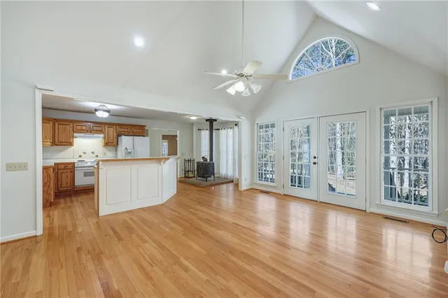 a kitchen with wooden floors and appliances