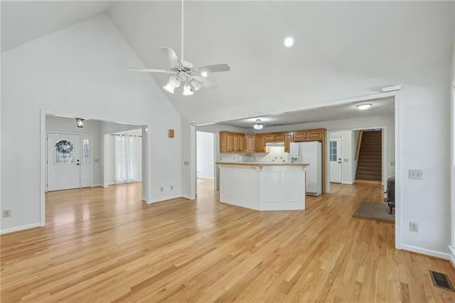 a kitchen with stainless steel appliances granite countertop a refrigerator a sink and a stove