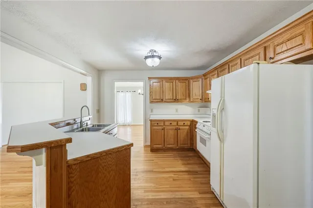 a kitchen with a sink cabinets and wooden floor