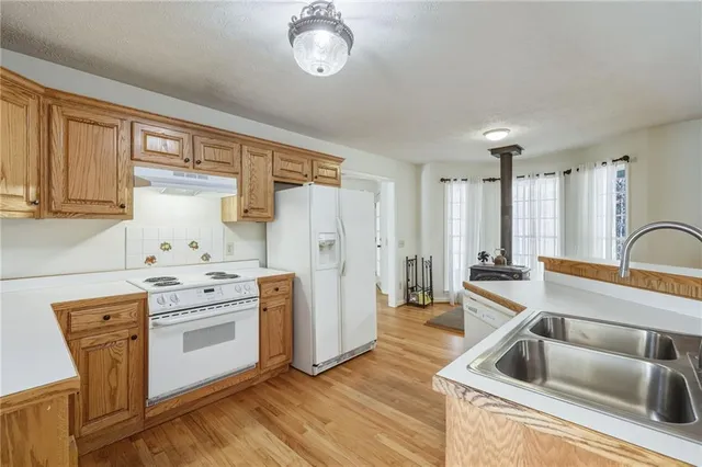 a view of a room with wooden floor and furniture