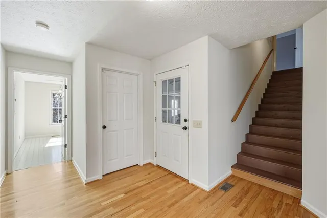 an empty room with a window and ceiling fan